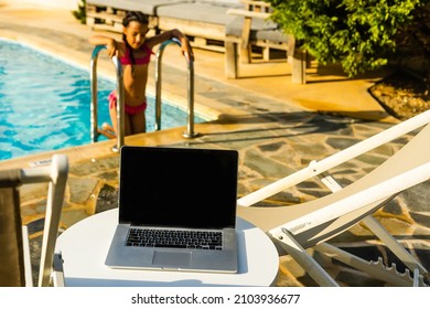 laptop computer on table pool background