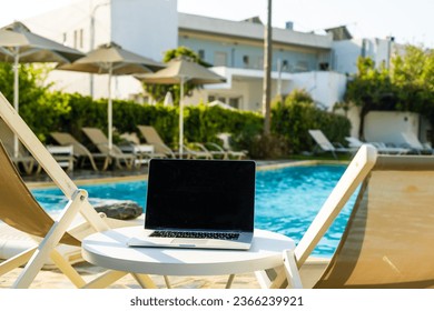 laptop computer on table pool background
