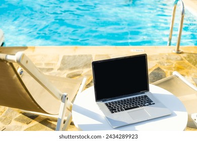 laptop computer on table pool background