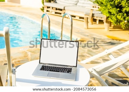 laptop computer on table pool background