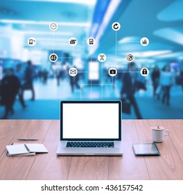 Laptop computer on wood table top with blur business people background - Shutterstock ID 436157542
