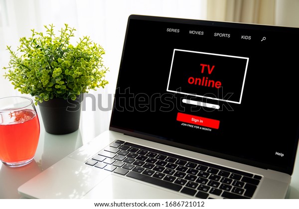 laptop computer with online tv application on table\
in room