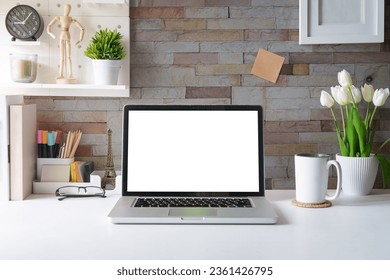 Laptop computer, picture frame, houseplant and stationery on white table. Modern workplace. - Powered by Shutterstock