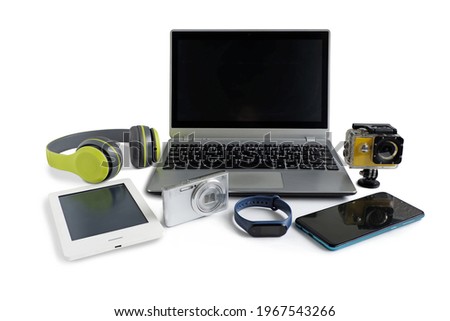 Laptop computer with smartphone and camera and ebook reader and other obsolete electronic gadgets on white background, Reuse and Recycle concept