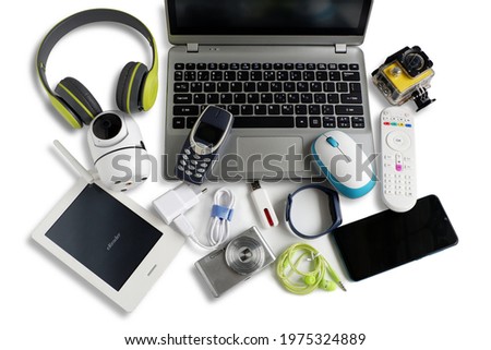 Laptop computer with smartphone and camera and ebook reader and other obsolete electronic gadgets on white background,Top view, Reuse and Recycle concept