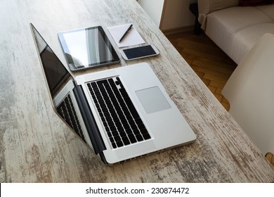 A Laptop Computer, A Tablet PC And A Smartphone On A Desktop. 