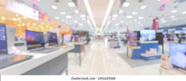 Laptop Computer And Television In Electronic Department Store Blurred Background