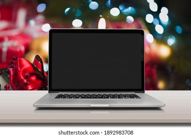 Laptop Computer With White Blank Mock Up Screen On Merry Christmas Table