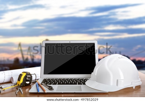 Laptop\
with construction tools on blue sky\
background