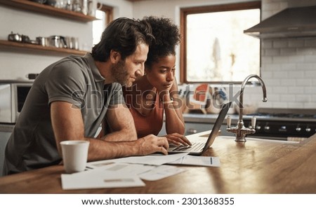 Laptop, couple and financial planning in a kitchen with documents for budget, savings and paying bills. Interracial, online and people with paperwork for taxes, mortgage and home loan application