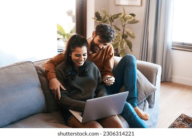 Laptop, credit card and happy couple on sofa, online shopping or cashback and spending in home. Smile, man and woman on couch to relax together, ecommerce or payment with bonding time and happiness. - Powered by Shutterstock