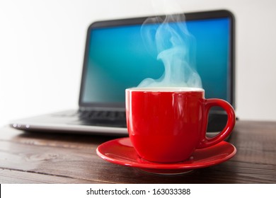 Laptop and a cup of coffee on a table - Powered by Shutterstock