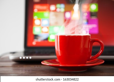 Laptop And A Cup Of Coffee On A Table