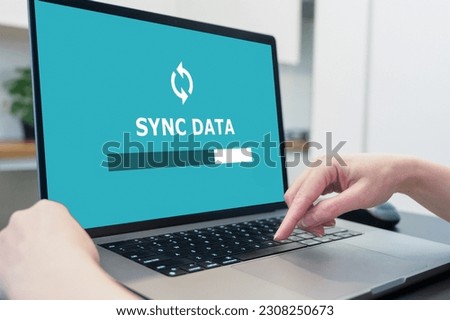 Laptop with data sync on screen. secure online backup to the cloud.