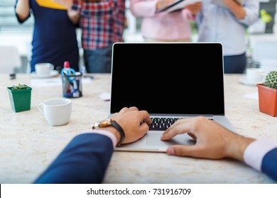 Laptop From The First Person On The Background Of A Group Of Office Workers