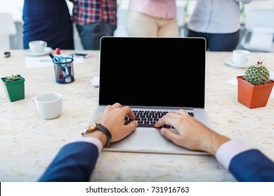 Laptop From The First Person On The Background Of A Group Of Office Workers