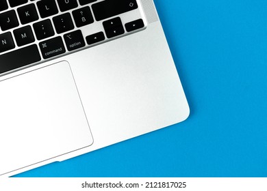 Laptop Flat Lay Blue Background. Office Workspace Table, Minimal Design Concept. Top View, Copy Space