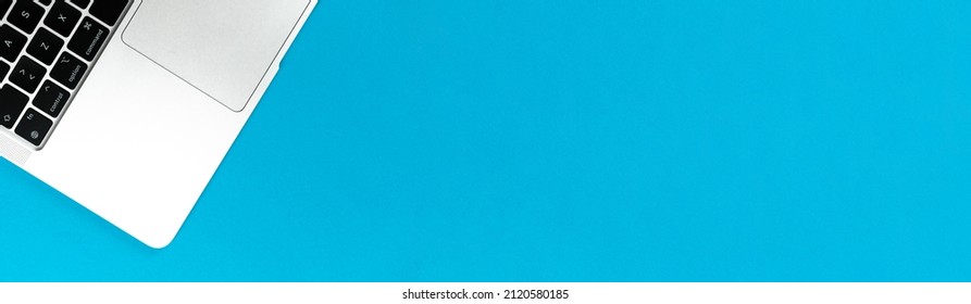 Laptop Flat Lay Blue Banner Background. Office Workspace Table, Minimal Design Concept. Top View, Copy Space