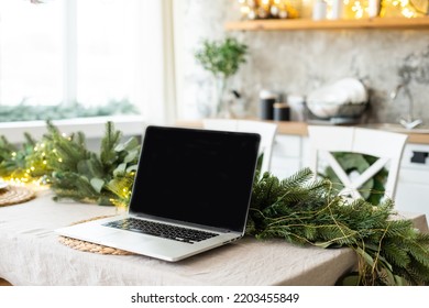 laptop with gift box and christmas lights background - Powered by Shutterstock