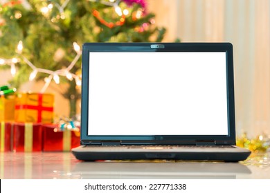 laptop with gift box and christmas lights background - Powered by Shutterstock