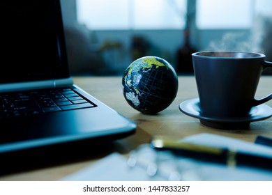 Laptop And Globe On The Desk