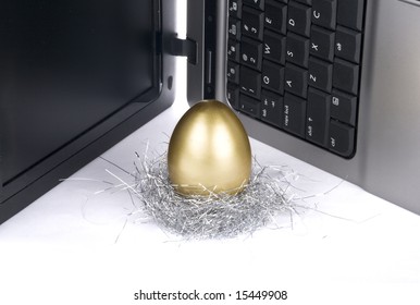 laptop and golden egg on white background - Powered by Shutterstock