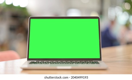 Laptop With Green Chroma Screen At Work