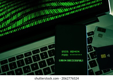 Laptop with green numbers on display. Credit cards, smartphone displaying successful login with credentials user and password. Remote banking technology, security privacy, hacker, cyber crime concept - Shutterstock ID 2062776524