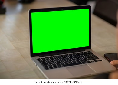 Laptop With Green Screen In Home Work Area. Home Office.