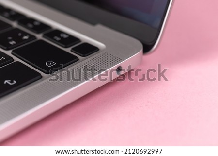 Laptop headphone jack close-up. Modern 3.5mm jack connection. Technology background
