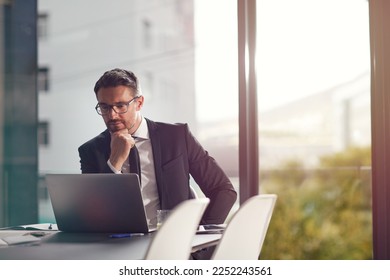 Laptop, idea and boardroom with a businessman working on research for future company growth. Computer, thinking and innovation with a male employee or manager in his office with review his strategy - Powered by Shutterstock