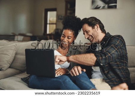 Laptop, interracial and entertainment with a couple watching a video using an online subscription service to relax. Computer, streaming or internet with a man and woman bonding together over a movie