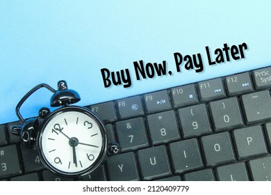 Laptop Keyboard And Alarm Clock With The Words Buy Now Pay Later