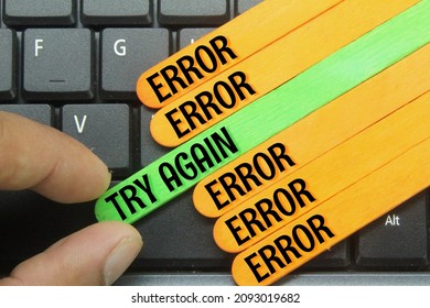 laptop keyboard, colored ice cream sticks with the words error and try again