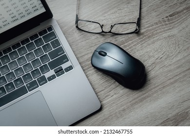 
Laptop keyboard, computer mouse and glasses. Working atmosphere on the table. Freelance. Business.