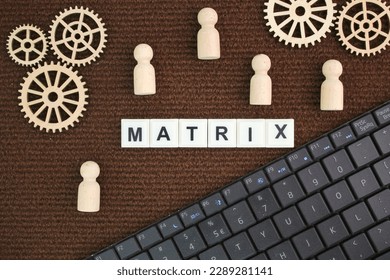 laptop keyboard, gear teeth and wooden figure with the word matrix. matriculation concept