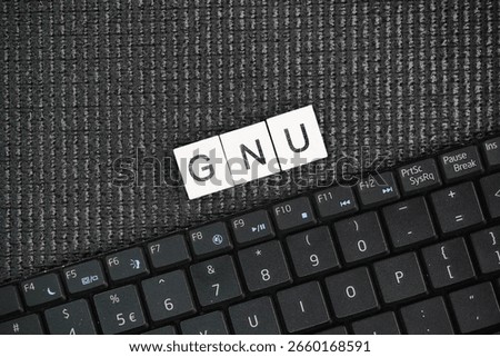 A laptop keyboard with GNU words. operating system composed of free software, developed by the GNU Project.