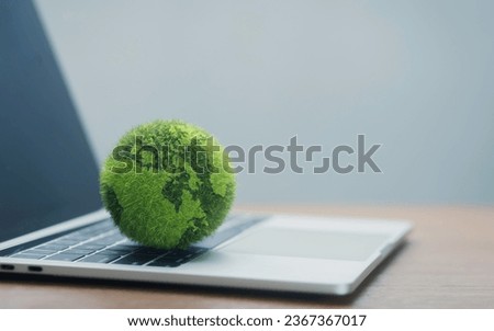 Laptop keyboard with green globe technology concept with nature concept, digital sustainability, green technology. Green Technology, Green IT, CSR and Clean Technology Ethical Concepts