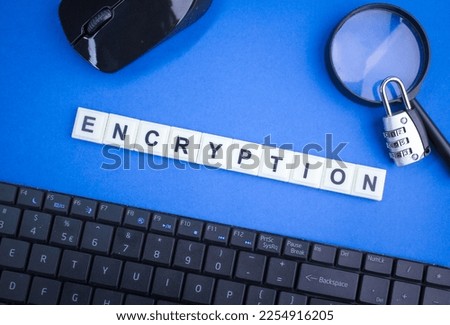 laptop keyboard, magnifying glass, mouse and keys with the word Encryption.