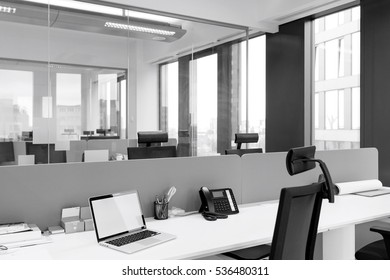 Laptop And Landline Phone On Desk At Office