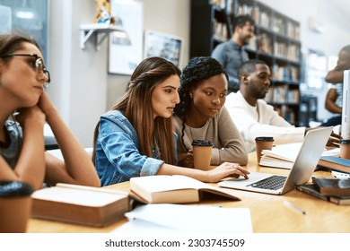 Laptop, library and university girl students studying together for education in preparation of a test or exam. Computer, college and scholarship with female friends searching for information online - Powered by Shutterstock