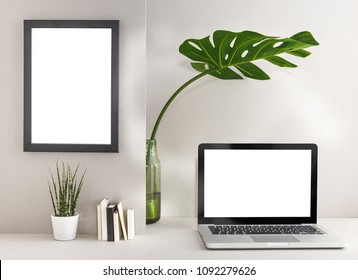 Laptop mac and photo frame on a grey wall and monstera plant in vase at stylish home workspace desk. Mock up. - Shutterstock ID 1092279626