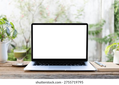 Laptop and matcha and notebook in front of window, cozy workspace