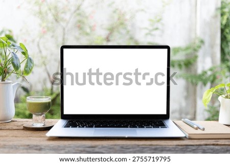Laptop and matcha and notebook in front of window, cozy workspace