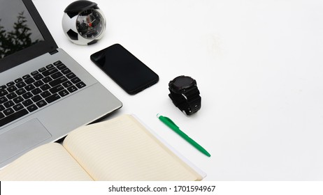 Laptop, Mobile Phone, Book, Comfortable work station setup in home - Powered by Shutterstock