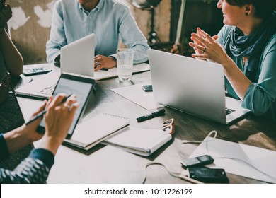 Laptop, mobile phone, tablet and documents on a working table in creative office. Successful teamwork and business startup concept. Toned image - Powered by Shutterstock