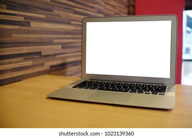 Laptop With Mock Up Blank Screen On Wooden Table In Front Of Coffeeshop Cafe Space For Text. Product Display Montage- Technology Concept.