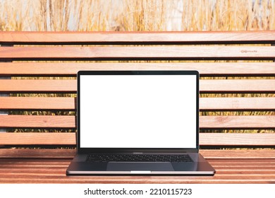 Laptop Mockup. Notebook With White Screen Morning City Urban Public Space On Background In Park Bench. Urban, And Remote Work And Study Concept. Empty Copy Space, Blank Screen Modern Laptop.