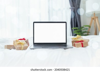 Laptop With A Mockup White Screen And A Gift Box On The White Background. Merry Christmas Concept.