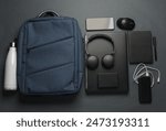 Laptop with Modern gadgets and accessories for work and study with Backpack on dark gray background. Top view. Flat lay